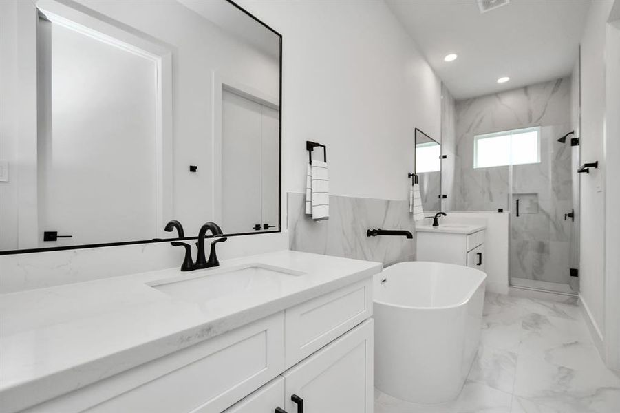 Enjoy the convenience of having an oasis for an ensuite bath featuring double sinks with large vanity, large soaking tub and a serene glass frame standing shower.