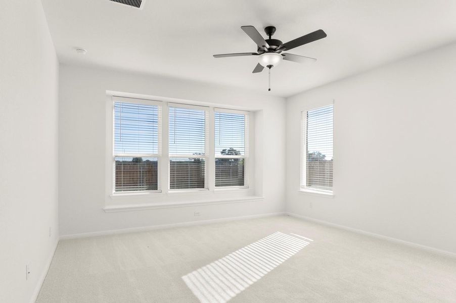 Empty room with light carpet and ceiling fan