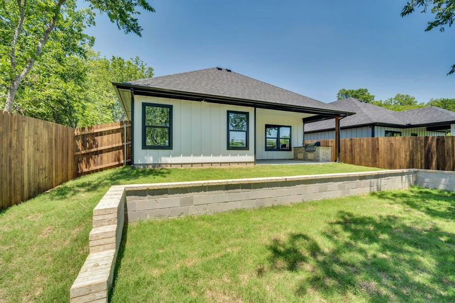 Generous backyard with retaining wall accent.  Great extra seating space.