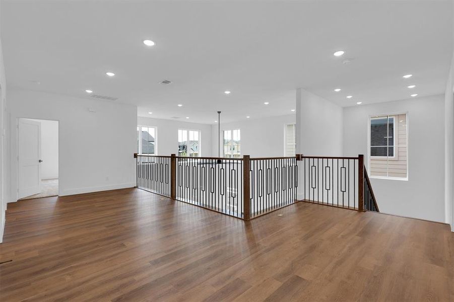 Spare room featuring wood finished floors and recessed lighting Spare room featuring wood finished floors and recessed lighting