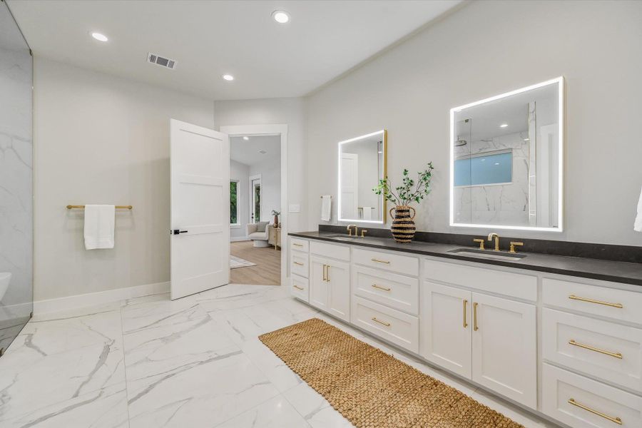 Full bath with double vanity, recessed lighting, a freestanding bath, a marble finish shower, and light marble finish floors