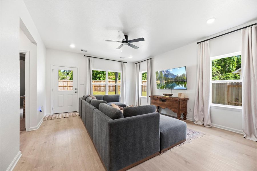 Family room with laminate flooring, ceiling fan and great backyard views. Family room with laminate flooring, ceiling fan and great backyard views.