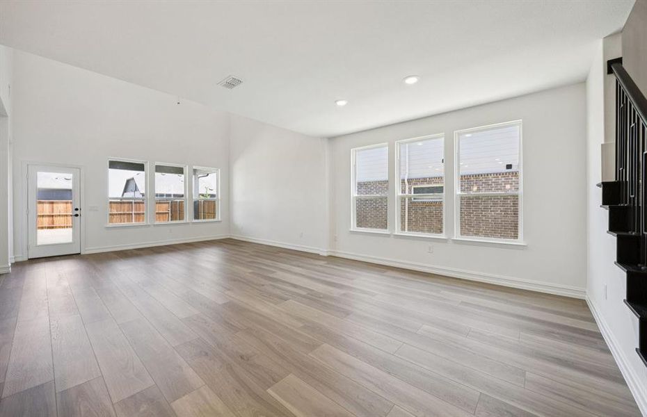 Spacious gathering room with large windows *real home pictured