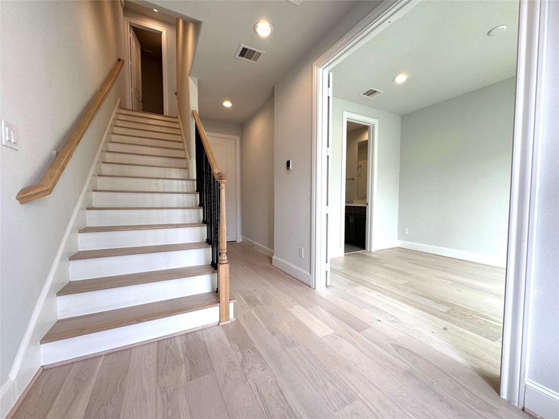 Gorgeous light-colored wood floors in the entryway.