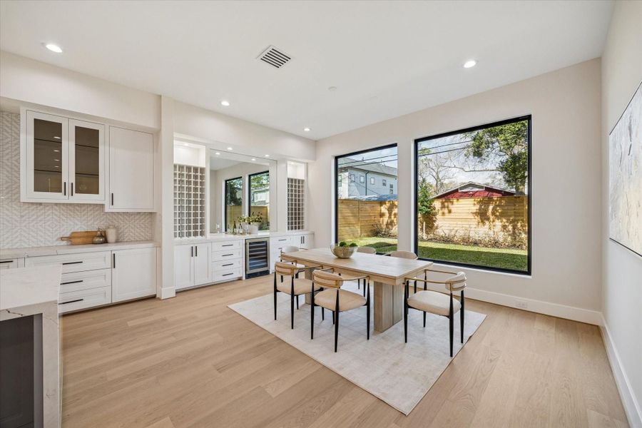 Illuminated display cabinets, subtle under-cabinet lighting, and refined design details showcase exceptional craftsmanship. Premium Thermador appliances elevate the kitchen, including a professional-grade gas range, dishwasher and microwave,  blending high performance with modern luxury.