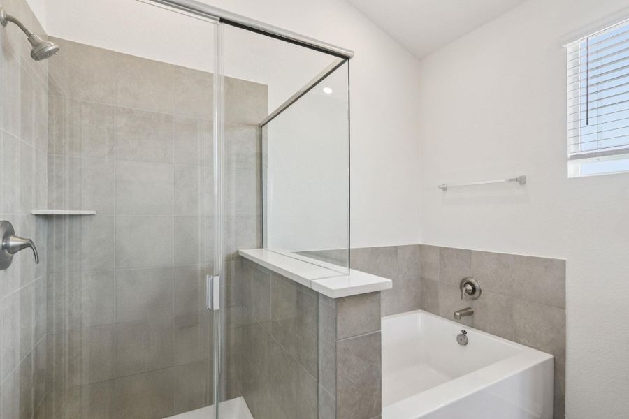 Full bathroom featuring a bath and a stall shower Full bathroom featuring a bath and a stall shower