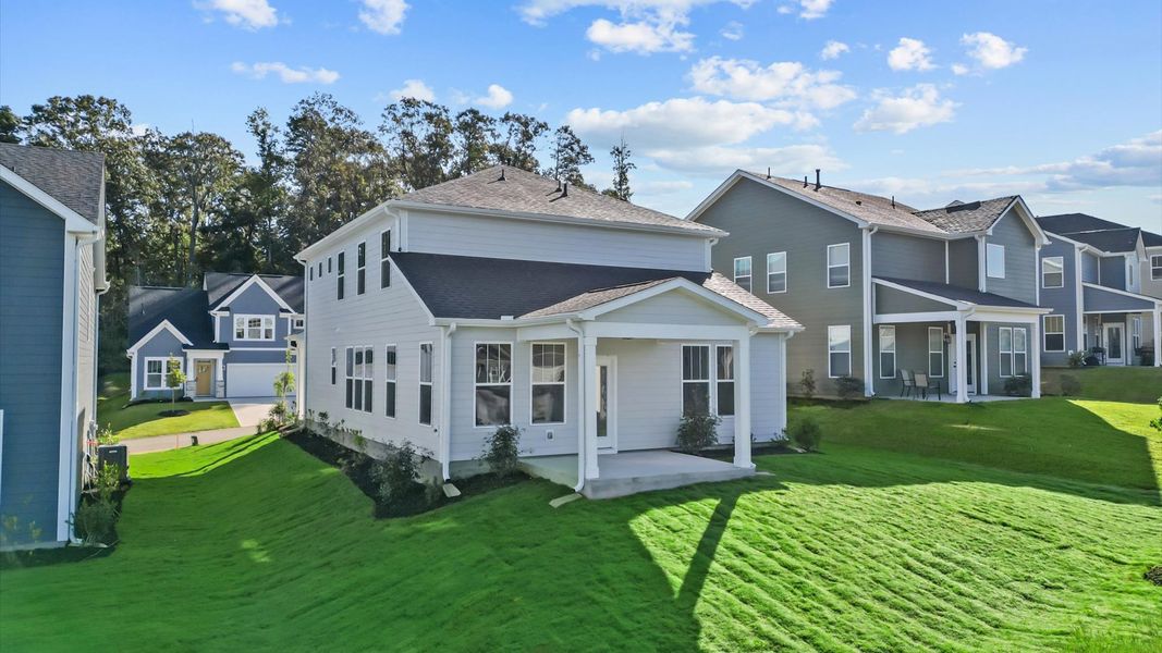 Rear covered porch creates a seamless extension of this home’s elegant design
