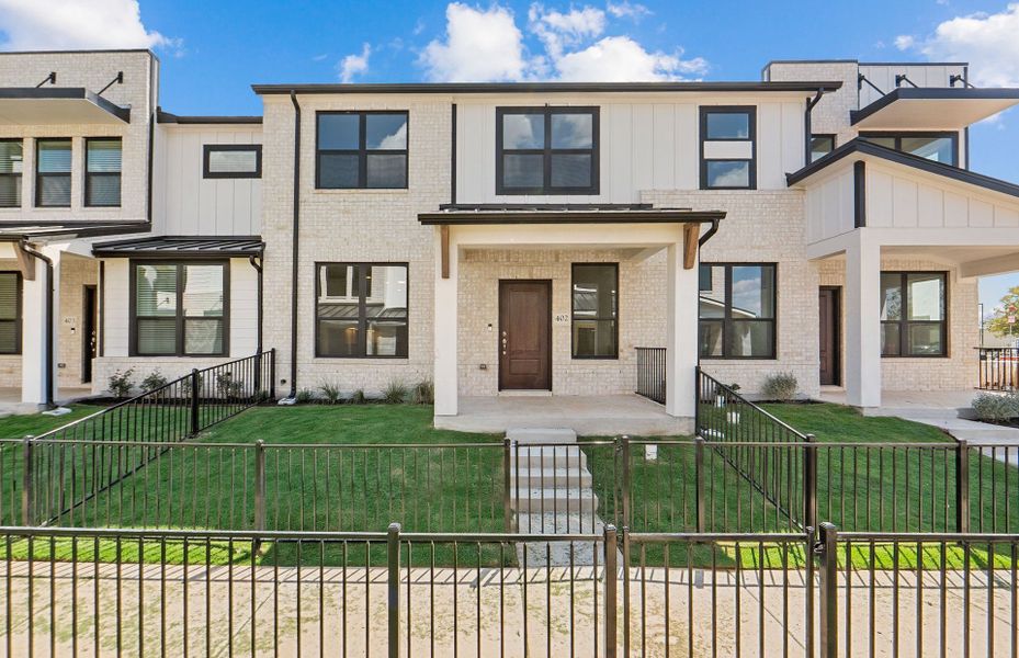 Front exterior of a new home in Monarch on Main, Round Rock, TX, highlighting curb appeal (Image 21). Front exterior of a new home in Monarch on Main, Round Rock, TX, highlighting curb appeal (Image 21).