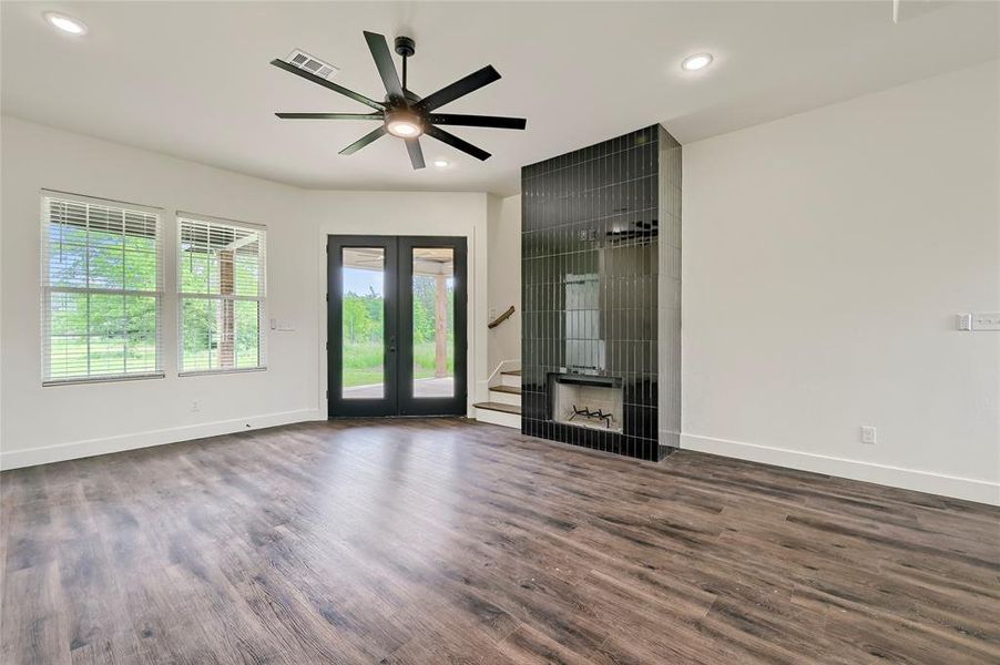 Empty room with baseboards, visible vents, wood finished floors, and stairway