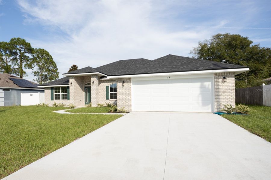 Front exterior of a new home in Palm Coast, Palm Coast, FL, highlighting curb appeal (Image 2).