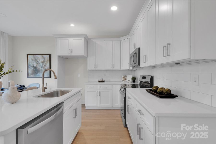 Open Kitchen with White Shaker Cabinets & Quartz Countertops