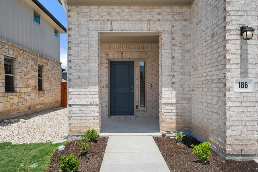 Front exterior of a new home in Crosswinds, Kyle, TX, highlighting curb appeal (Image 24). Front exterior of a new home in Crosswinds, Kyle, TX, highlighting curb appeal (Image 24).