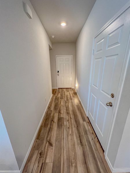 Hallway with light wood-style flooring