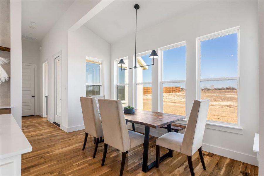 Dining room featuring wood-type flooring and an inviting chandelier