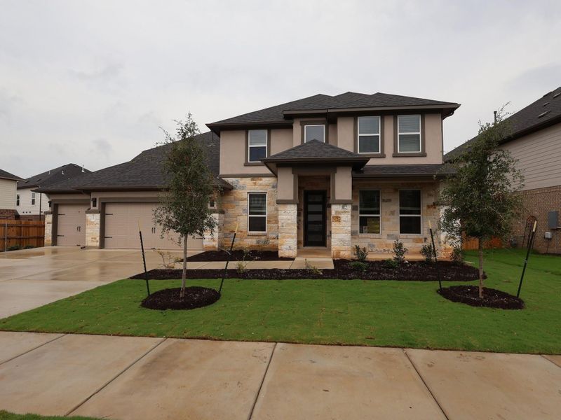Front exterior of a new home in Edgewood, Leander, TX, highlighting curb appeal (Image 1). Front exterior of a new home in Edgewood, Leander, TX, highlighting curb appeal (Image 1).