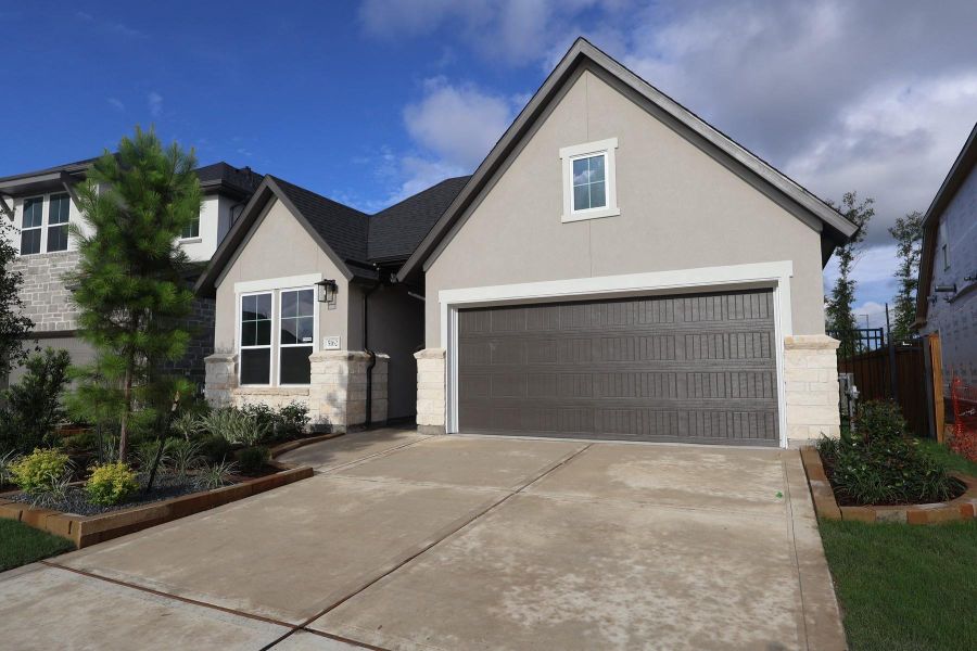 Front exterior of a new home in Woodson’s Reserve, Spring, TX, highlighting curb appeal (Image 13). Front exterior of a new home in Woodson’s Reserve, Spring, TX, highlighting curb appeal (Image 13).
