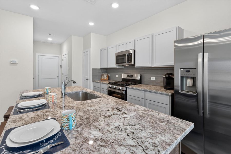 Granite countertops paired with stainless steel appliances and sleek cabinetry for a clean, contemporary finish. Granite countertops paired with stainless steel appliances and sleek cabinetry for a clean, contemporary finish.