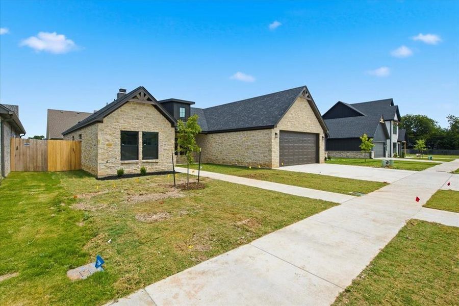 Front exterior of a new home in , Woodway, TX, highlighting curb appeal (Image 21). Front exterior of a new home in , Woodway, TX, highlighting curb appeal (Image 21).