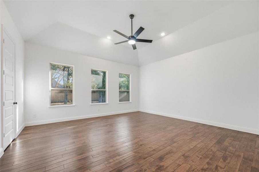 Unfurnished room with dark wood-type flooring, vaulted ceiling, recessed lighting, and ceiling fan