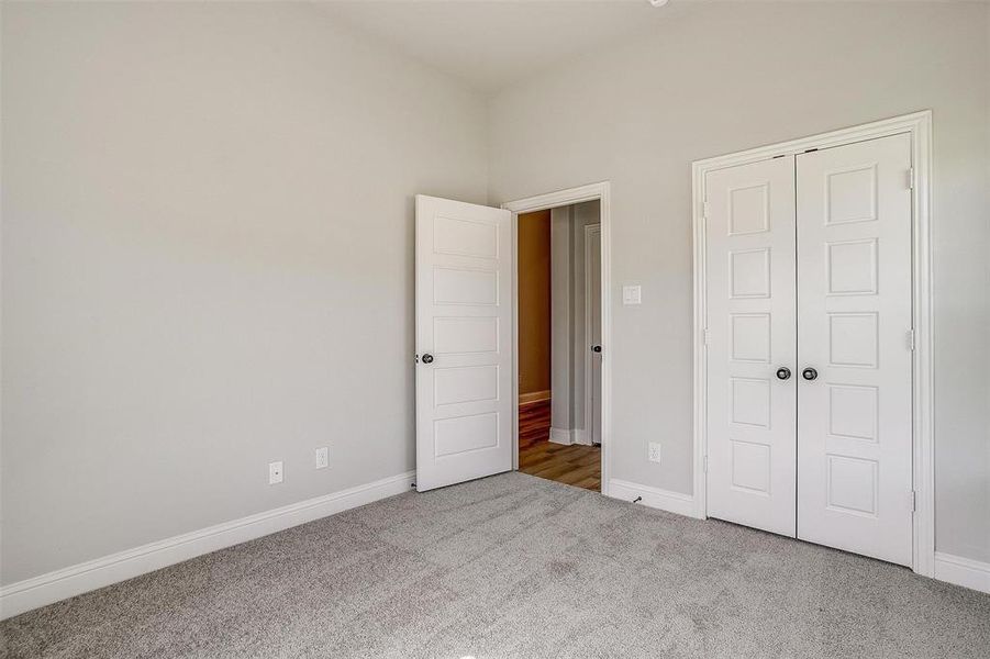 Unfurnished bedroom featuring a closet and carpet floors