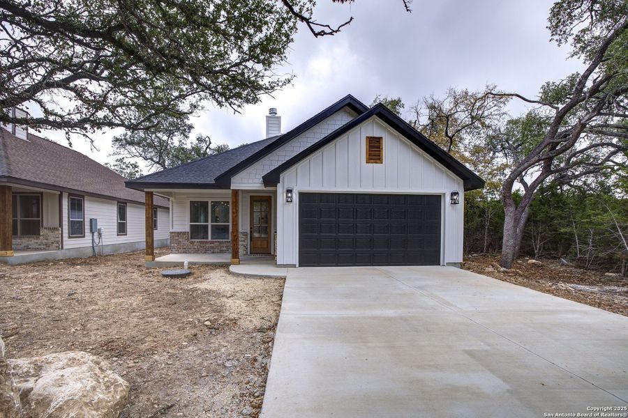 Front exterior of a new home in , Wimberley, TX, highlighting curb appeal (Image 21).