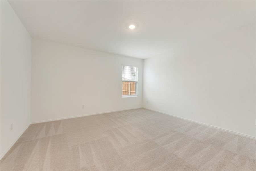 Empty room featuring light colored carpet