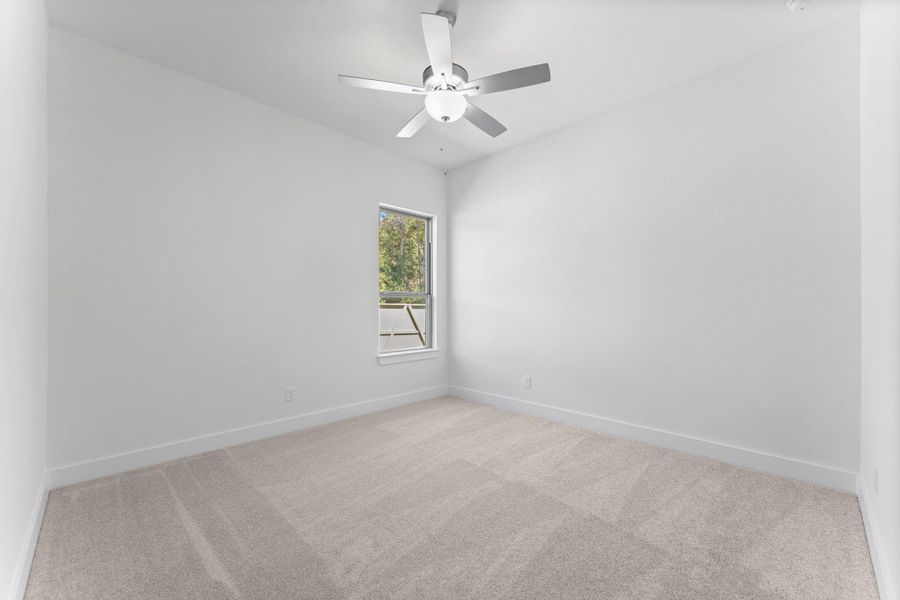 Bedroom 2 with tall ceilings and a ceiling fan. Bedroom 2 with tall ceilings and a ceiling fan.