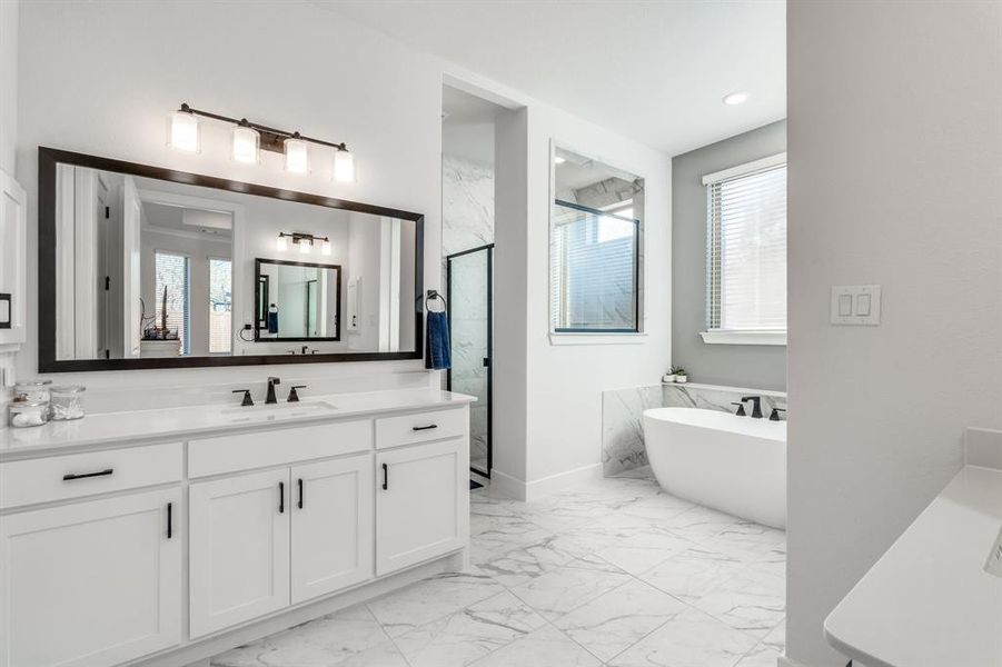 Bathroom featuring vanity and plus walk in shower