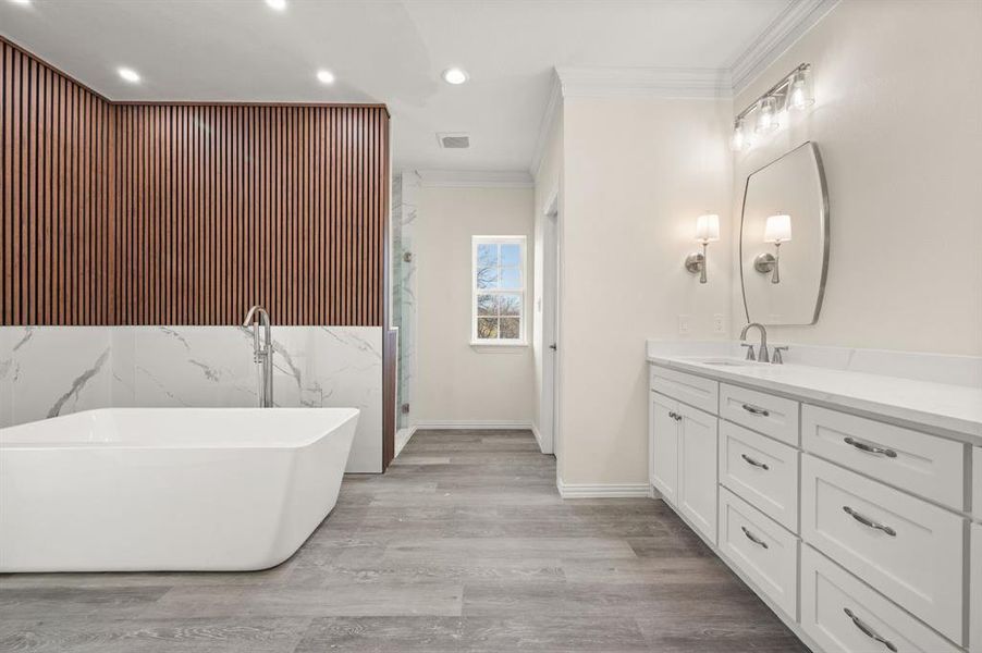 Full bath with recessed lighting, an accent wall, a soaking tub, vanity, and a marble finish shower Full bath with recessed lighting, an accent wall, a soaking tub, vanity, and a marble finish shower