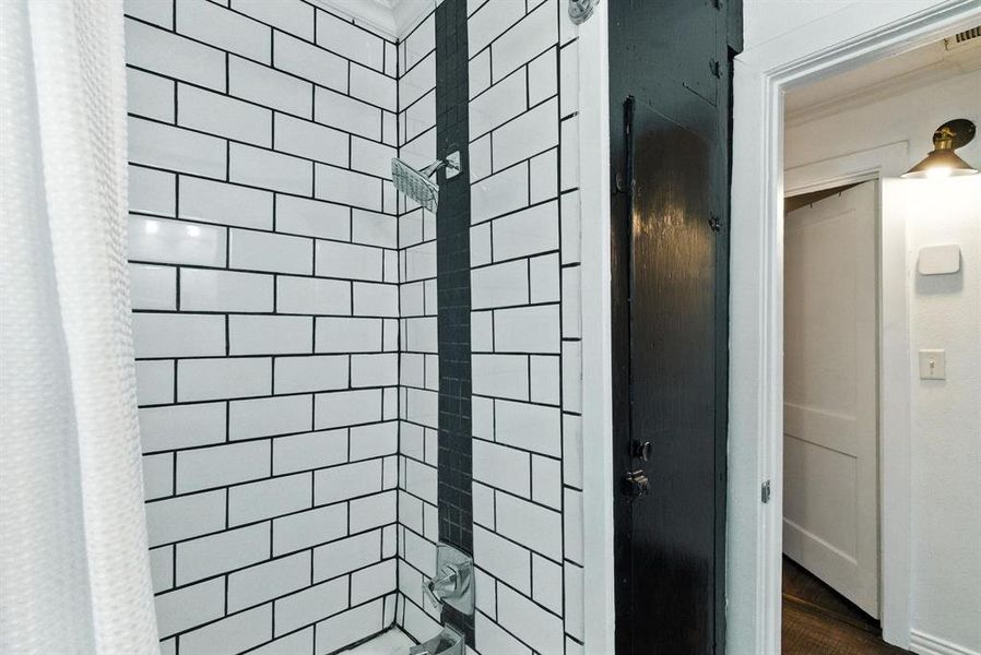 Full bath featuring wood finished floors Full bath featuring wood finished floors