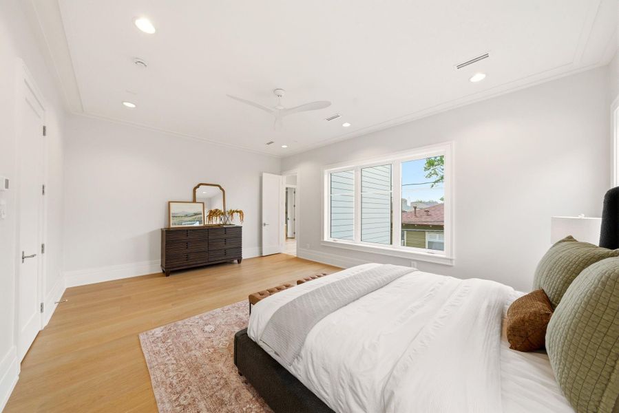 Alternate view of the oversized primary suite showcasing expansive layout and large picture windows. Alternate view of the oversized primary suite showcasing expansive layout and large picture windows.