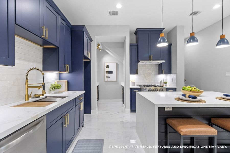 Cooking feels effortless with the sleek navy cabinetry, gold fixtures, and plenty of counter space to spread out and create. Cooking feels effortless with the sleek navy cabinetry, gold fixtures, and plenty of counter space to spread out and create.