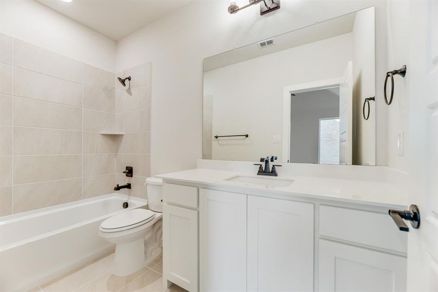 Bathroom with shower / washtub combination, light tile patterned floors, and vanity Bathroom with shower / washtub combination, light tile patterned floors, and vanity