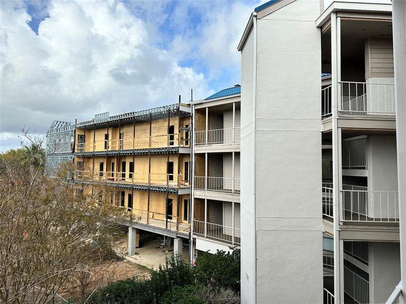 This is the building under construction. Unit 203 is the middle floor section, and the second unit doorway from the left.