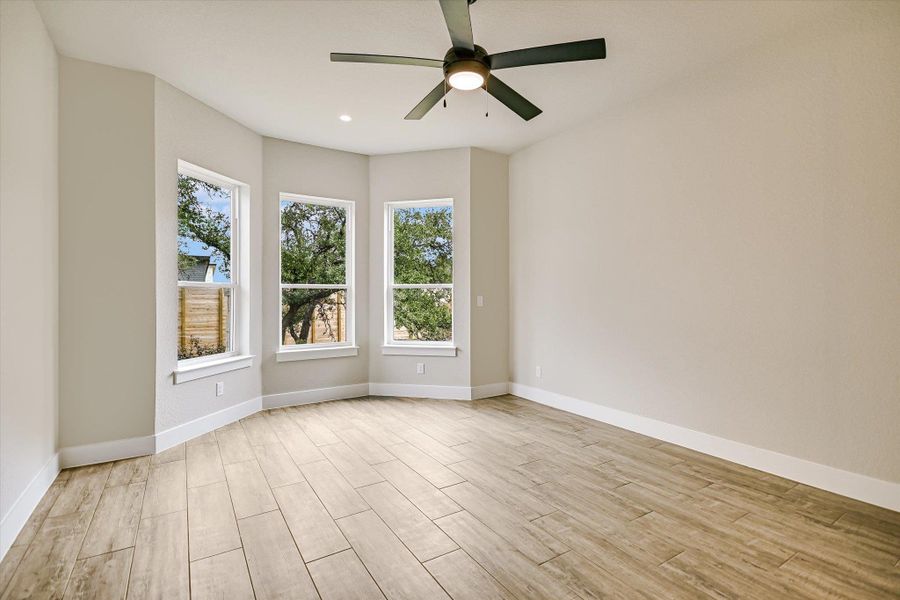 Unfurnished room with a ceiling fan, wood tiled floors, and recessed lighting