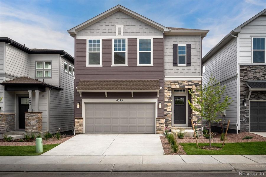 Front exterior of a new home in Trailside at Cottonwood Creek, Colorado Springs, CO, highlighting curb appeal (Image 1).