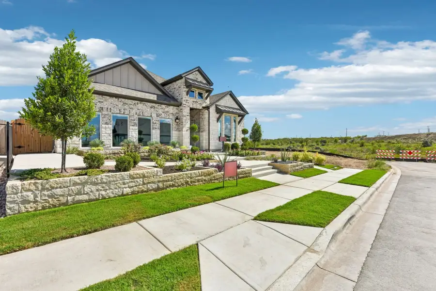Representative exterior photo of a completed home built from the Enfield by Taylor Morrison in Eastwood, Manor, TX (Image 24).