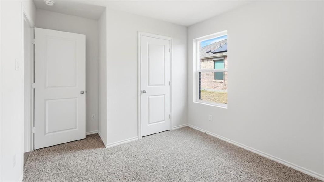 Unfurnished bedroom featuring light colored carpet and a closet Unfurnished bedroom featuring light colored carpet and a closet