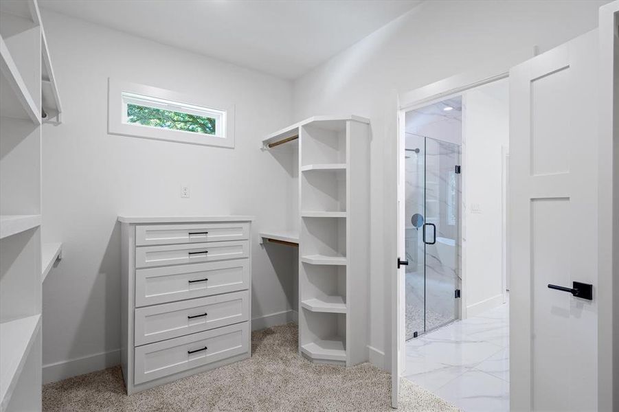 Spacious closet featuring light carpet Spacious closet featuring light carpet