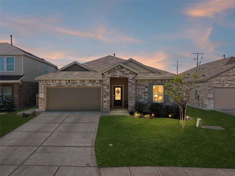 Single-story residence featuring a brick and stone facade Single-story residence featuring a brick and stone facade
