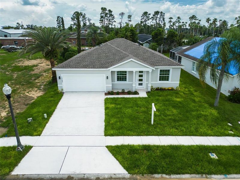 Front exterior of a new home in , Kissimmee, FL, highlighting curb appeal (Image 34).