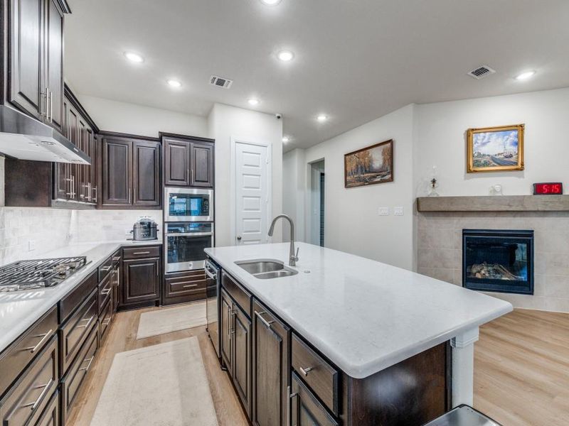 Wow! Great kitchen. Everything is pristine. Plenty of cabinets and extra seating at the island.