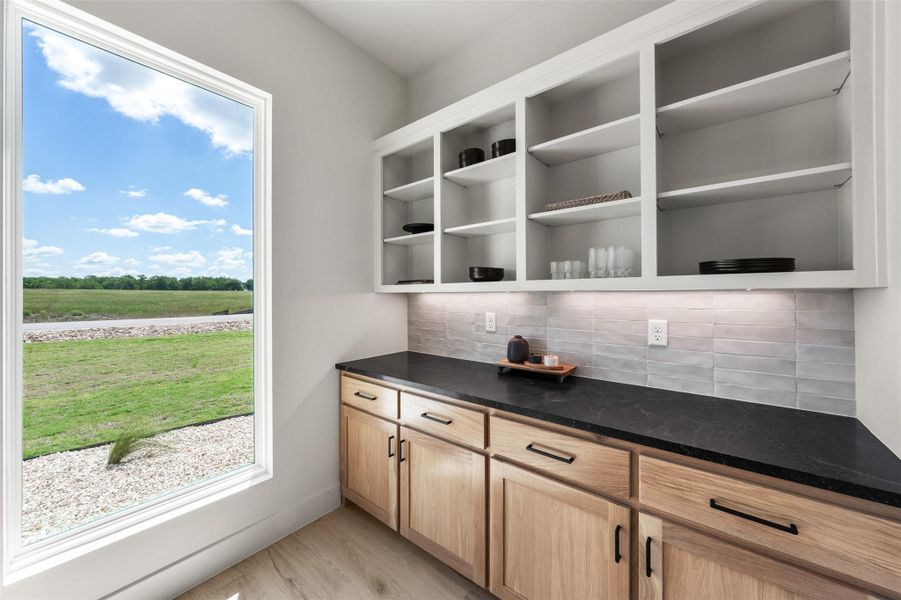 Working pantry with tasteful backsplash and light wood-style flooring Working pantry with tasteful backsplash and light wood-style flooring