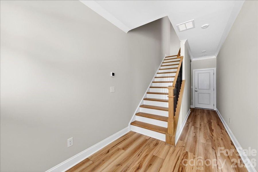 Foyer with oak box stairs and open rails