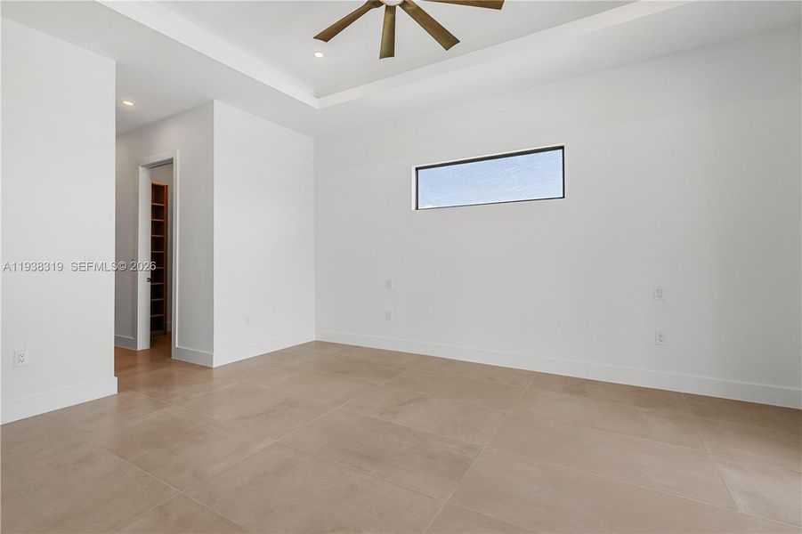 The contemporary primary bedroom offers a spacious, stylish retreat with modern finishes and natural light.