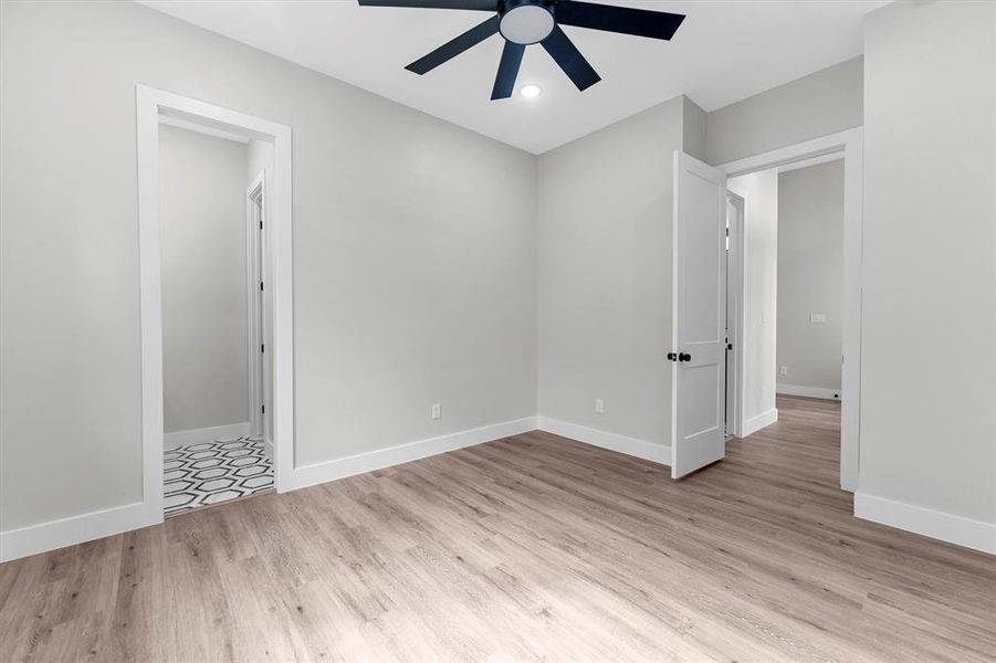 Second bedroom with ceiling fan and walk-in closet