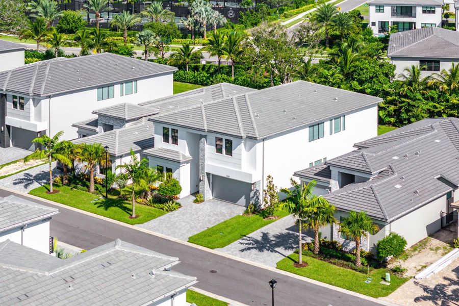 Front exterior of a new home in Lotus Edge, Boca Raton, FL, highlighting curb appeal (Image 2).