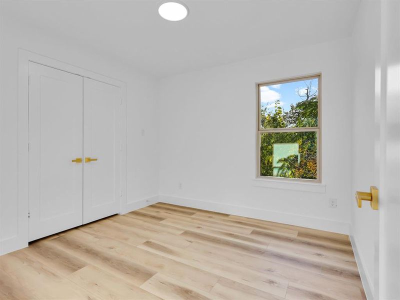 Unfurnished bedroom with a closet and light hardwood / wood-style flooring