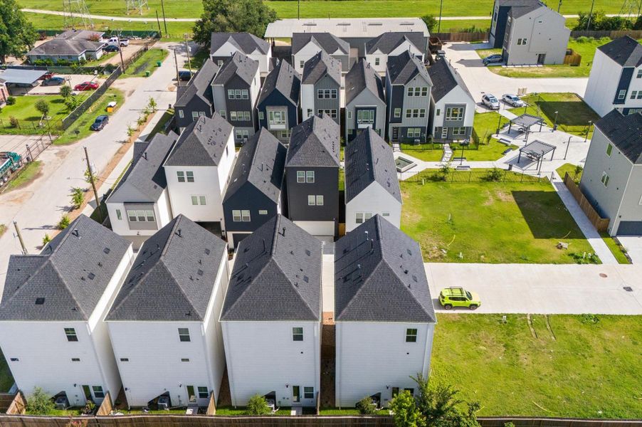 Showcasing the full scope of the neighborhood, this stunning aerial view captures the community’s thoughtful layout, lush green spaces, and inviting shared amenities. This bird’s-eye perspective highlights the seamless blend of architecture and nature. Ideal for getting a true sense of scale, proximity, and lifestyle, this elevated view paints a vivid picture of what it means to live here. Showcasing the full scope of the neighborhood, this stunning aerial view captures the community’s thoughtful layout, lush green spaces, and inviting shared amenities. This bird’s-eye perspective highlights the seamless blend of architecture and nature. Ideal for getting a true sense of scale, proximity, and lifestyle, this elevated view paints a vivid picture of what it means to live here.