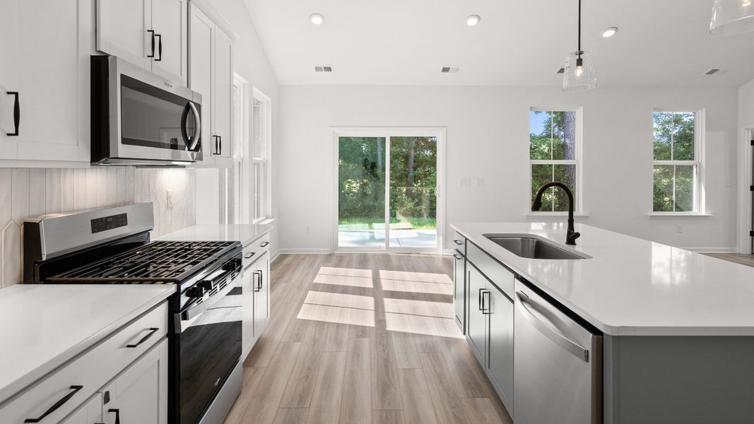 Kitchen with seamless dining space and views to the rear covered porch